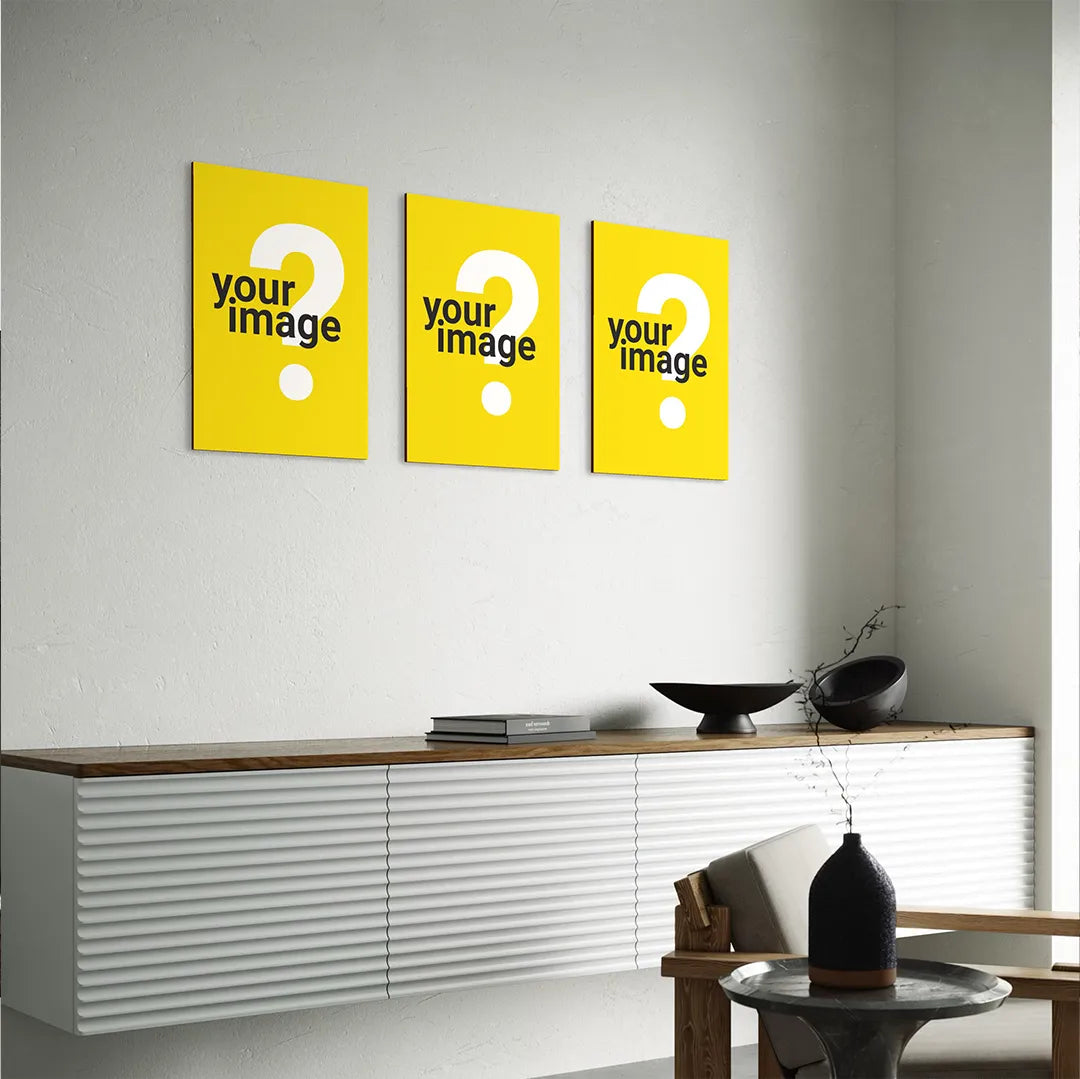 three vertical wooden posters arranged above modern white sideboard with wooden top styled with minimalist black decor pieces in contemporary interior